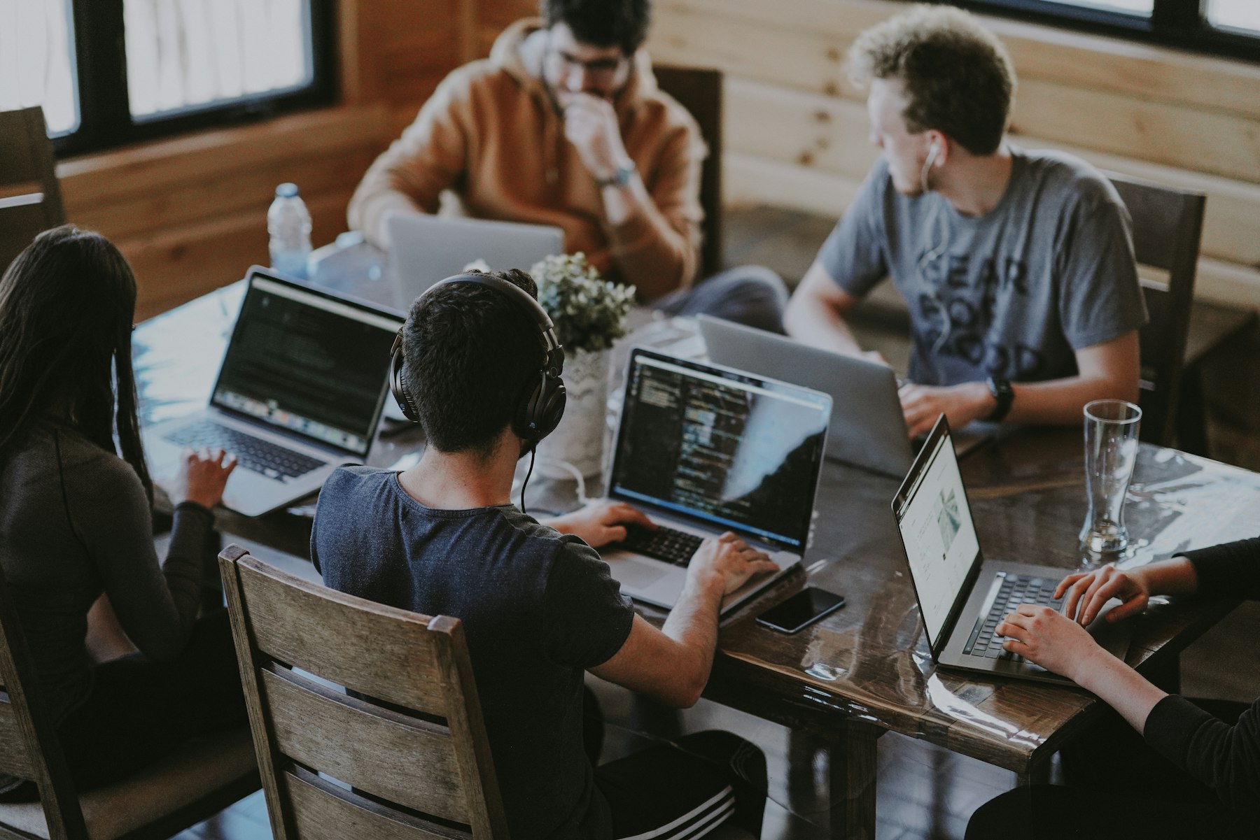 A real photograph of shared team workspace with connected communication channels